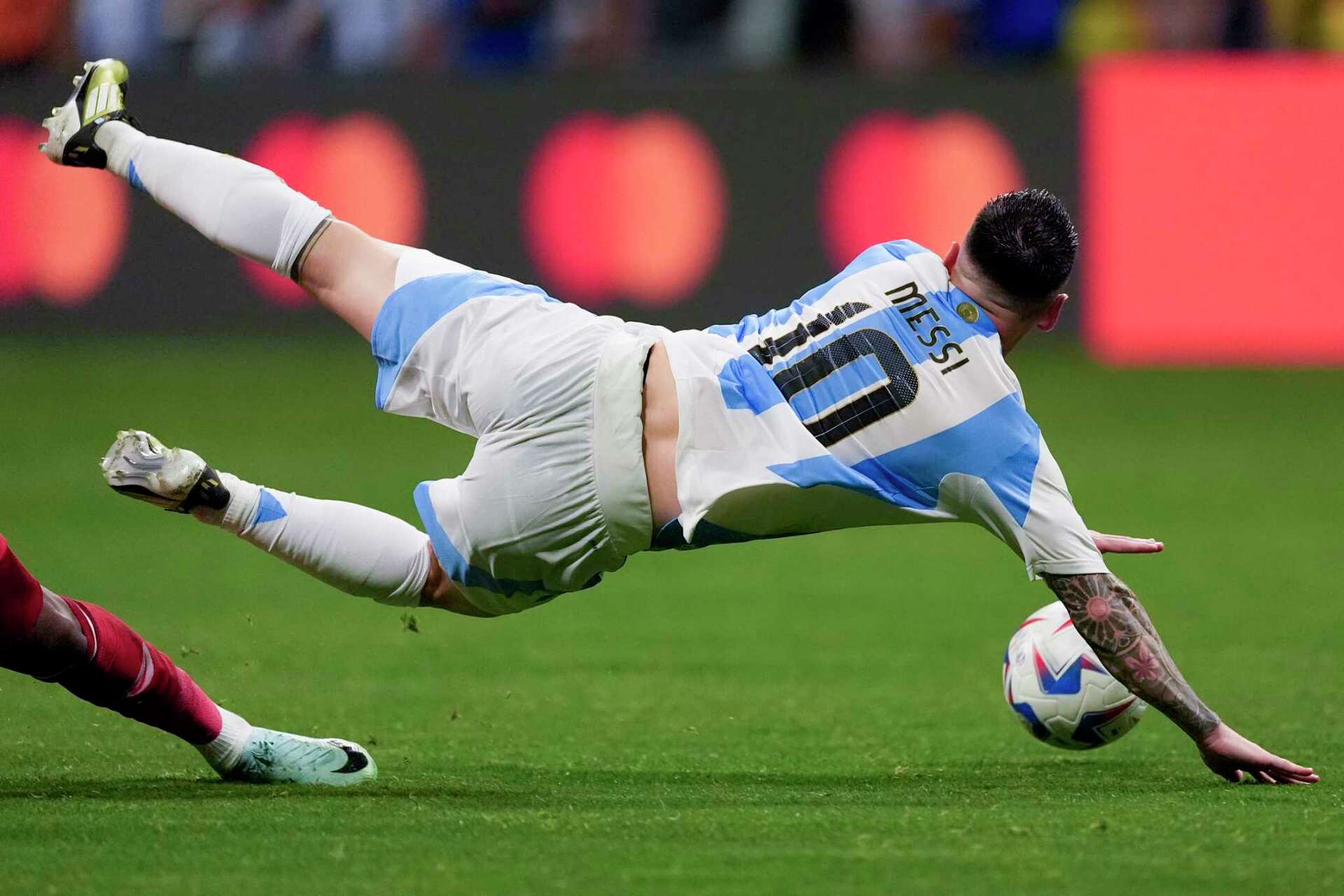 Lionel Messi of Argentina exits match due to suspected lower-body injury