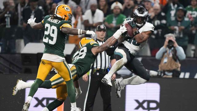 Jordan Love, Packers quarterback, assisted off the field during game against Eagles